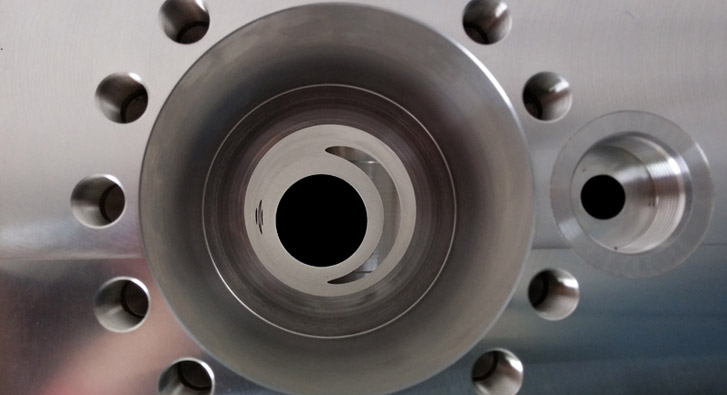 Precision bore and threaded holes on aluminum manifold. Deep hole drilling and multiple large bores with “blind” intersections located internally.